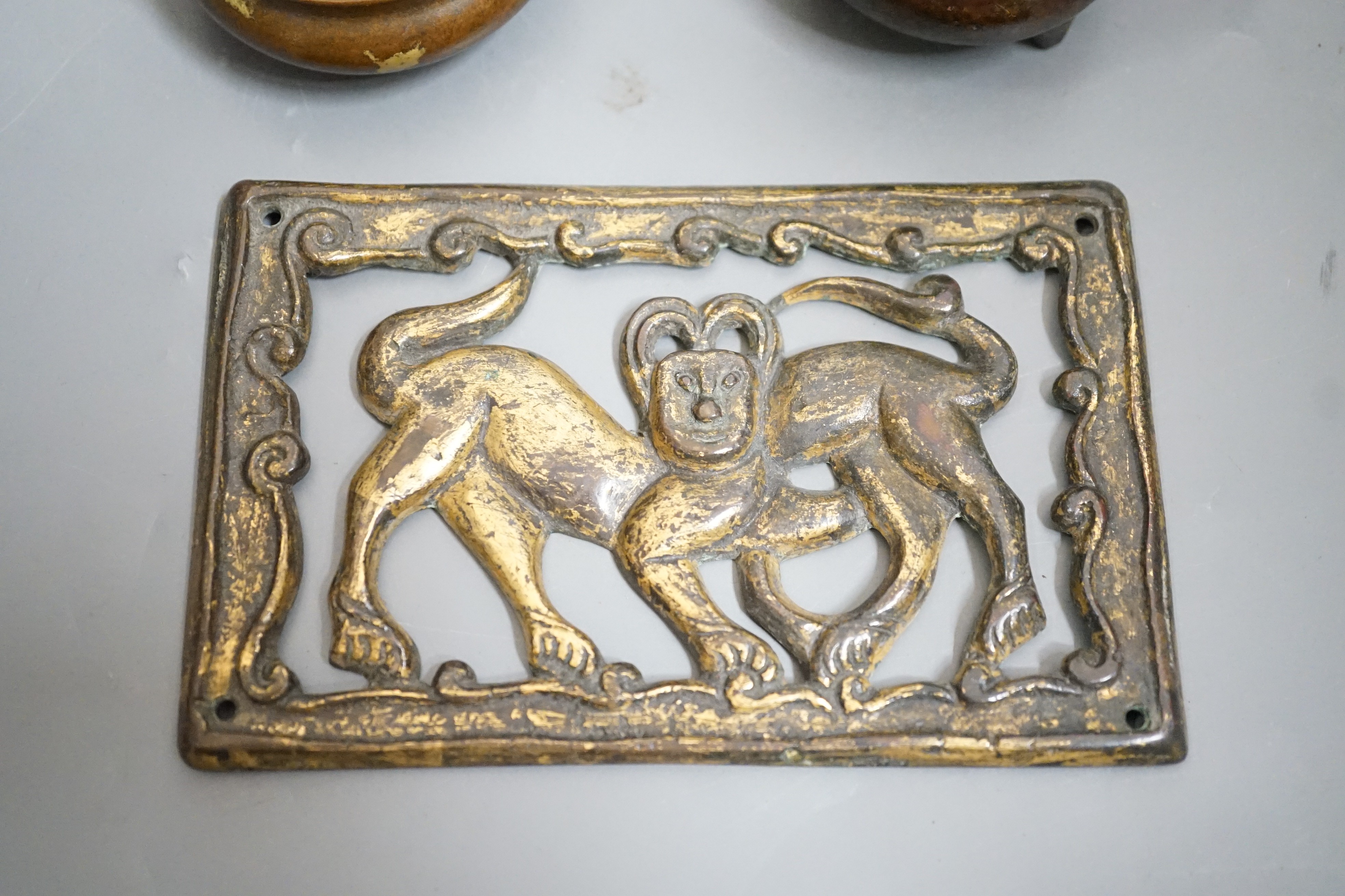 Two small bronze two handled censers and an Ordos style pierced bronze monkey panel, 13cms wide